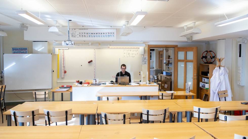 Johan Egerhall undervisar från ett klassrum som står helt tomt men eleverna deltar aktivt genom internetundervisningen.
