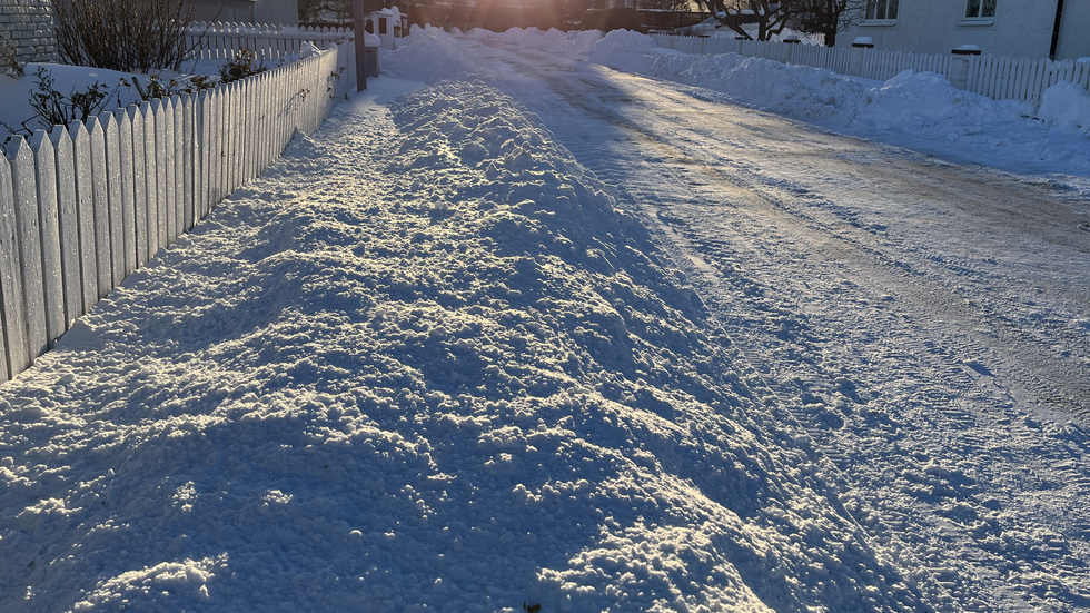 Mängder av snö har lagts längs tomtgränsen. Här ska man egentligen skotta "snarast" som det står i reglerna. Men det blir ett tungt arbete, kan man konstatera.