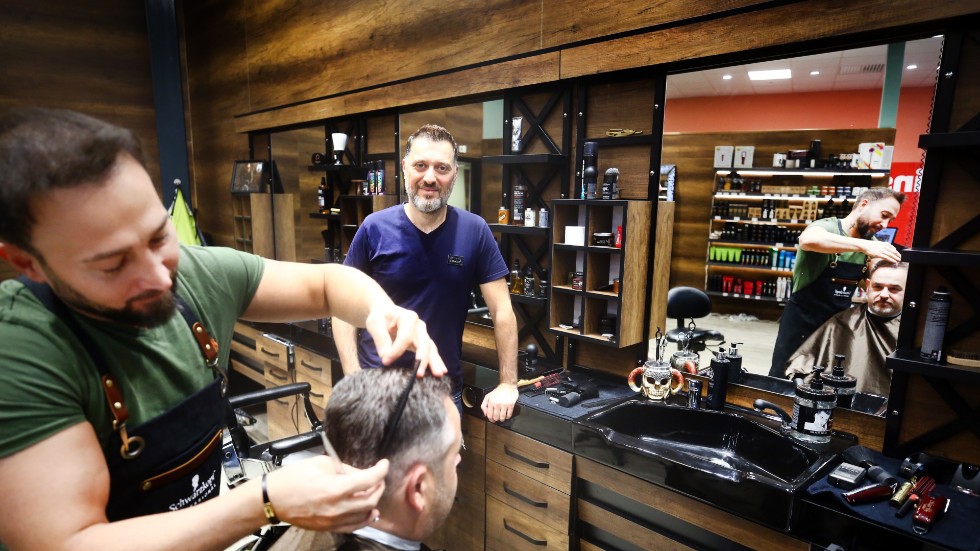 "Herrar med skägg och damer med långt hår är välkomna, så folk inte tror att vi bara är barberare", säger Malek Dowm, i mitten av bilden. Kollegan Claud Aroussi fixar till skägg och hår på Jörgen Fredriksson som var på besök under salongens smygöppning.