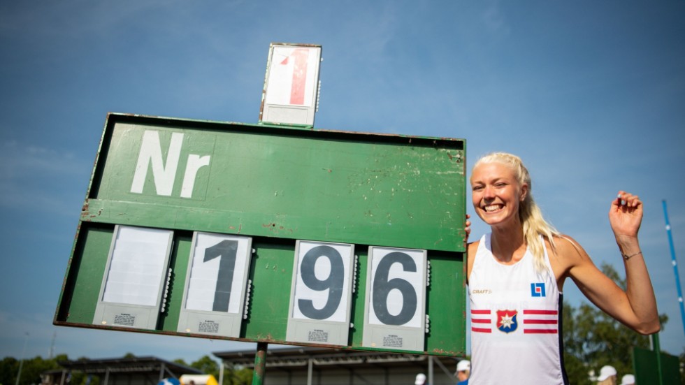 Maja Nilsson poserar vid resultattavlan efter att hon tagit just höjden som står på den. Dagen efter så meddelade Sveriges olympiska kommitté att Motalatjejen är uttagen i den svenska OS-truppen.