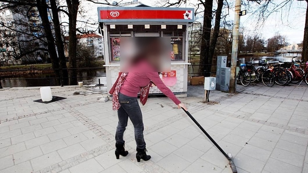 Rävens mamma, som är dömd för penningtvätt i samband med sonens affärer, sopar framför glasskiosken. Bilden togs för några år sedan i samband med en artikel om vårens ankomst i Uppsala. 
