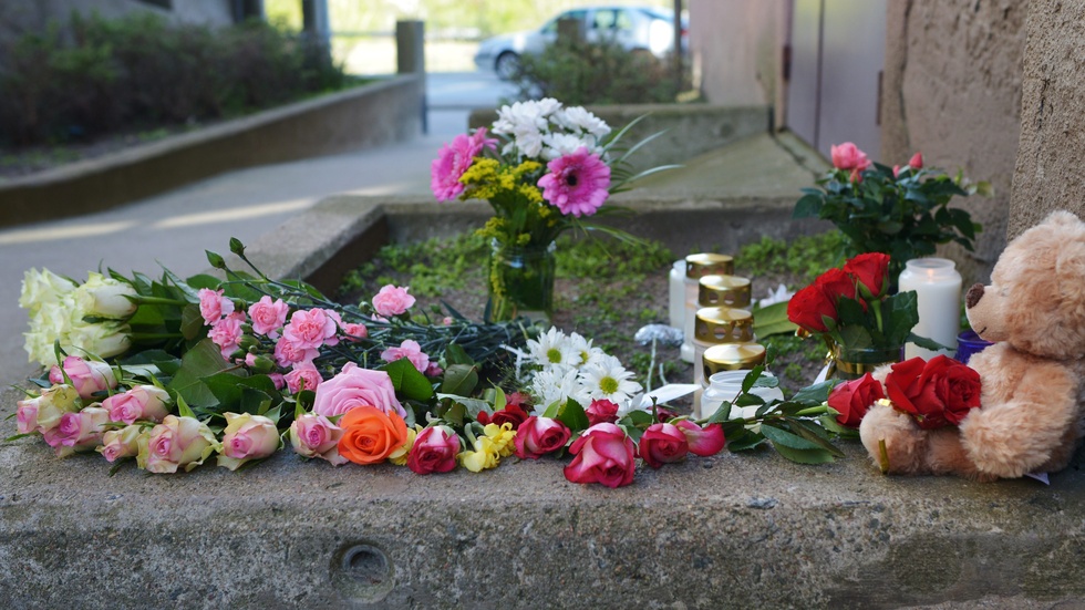 Karlskrona 2014: Blommor, ljus och en nalle utanför porten till det hus där den åttaåriga flickan som mördades bodde. Arkivbild.